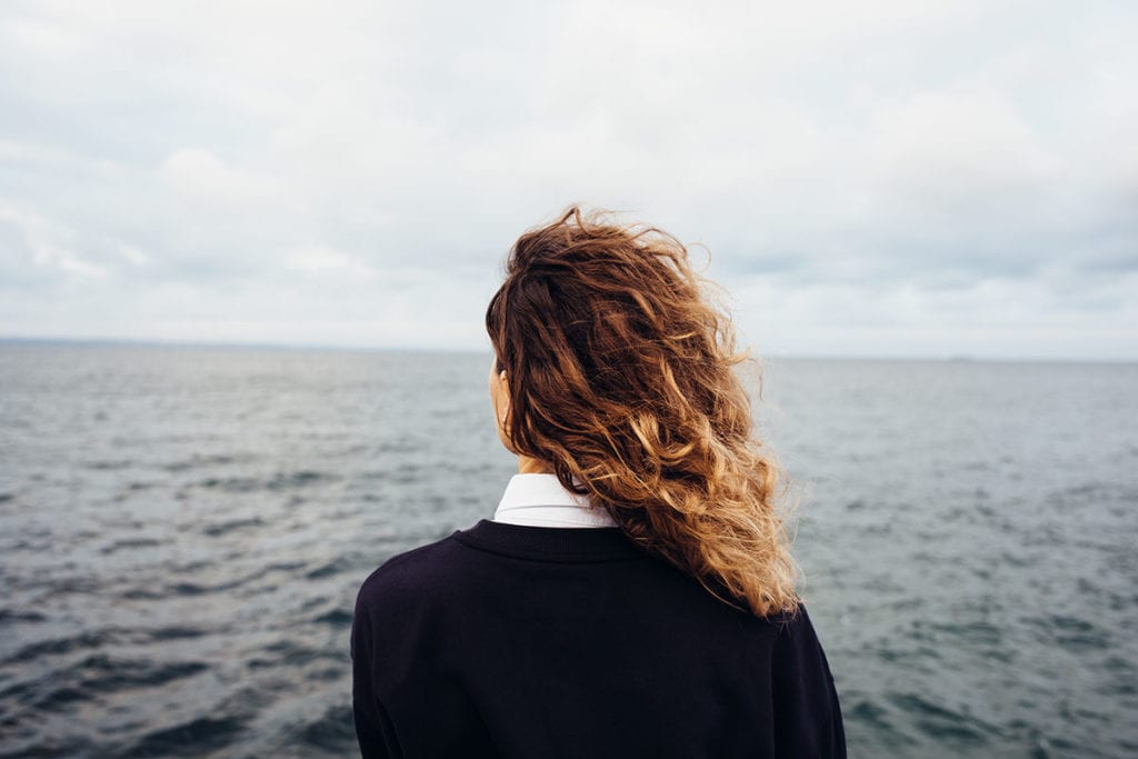 woman overlooking the ocean worried about the Signs of Heroin Use in a loved one
