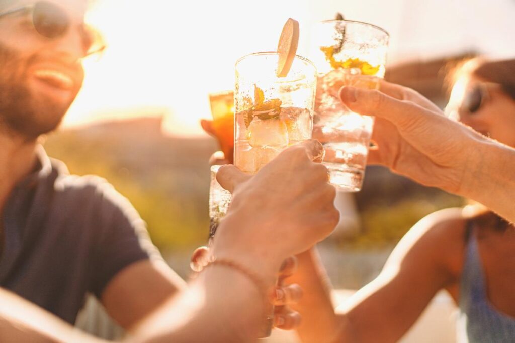 people clinking glasses and learning about social drinking