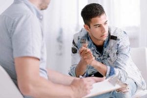 man works with therapist at mens addiction treatment center