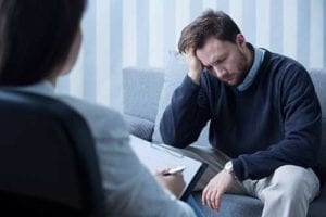 man talks with therapist at mens rehab center program