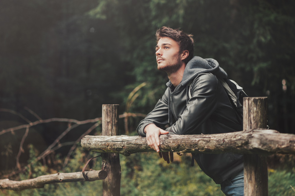 Man in nature thinking on expectations in addiction recovery