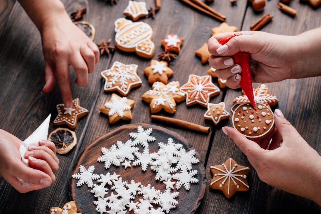 people decorating cookies discuss hosting a sober holiday celebration