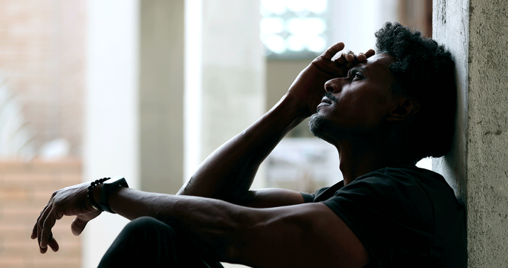 Man leans against wall and wonders "can alcohol make you go blind?"