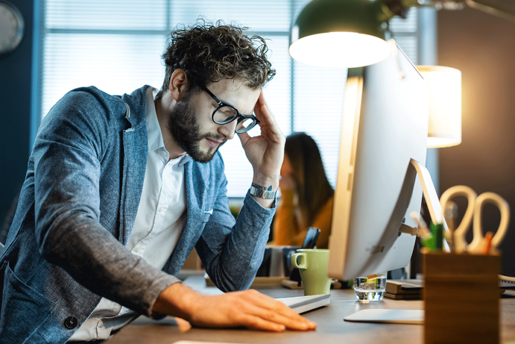 Man sits at his computer, wondering if he has cannabis-induced psychosis