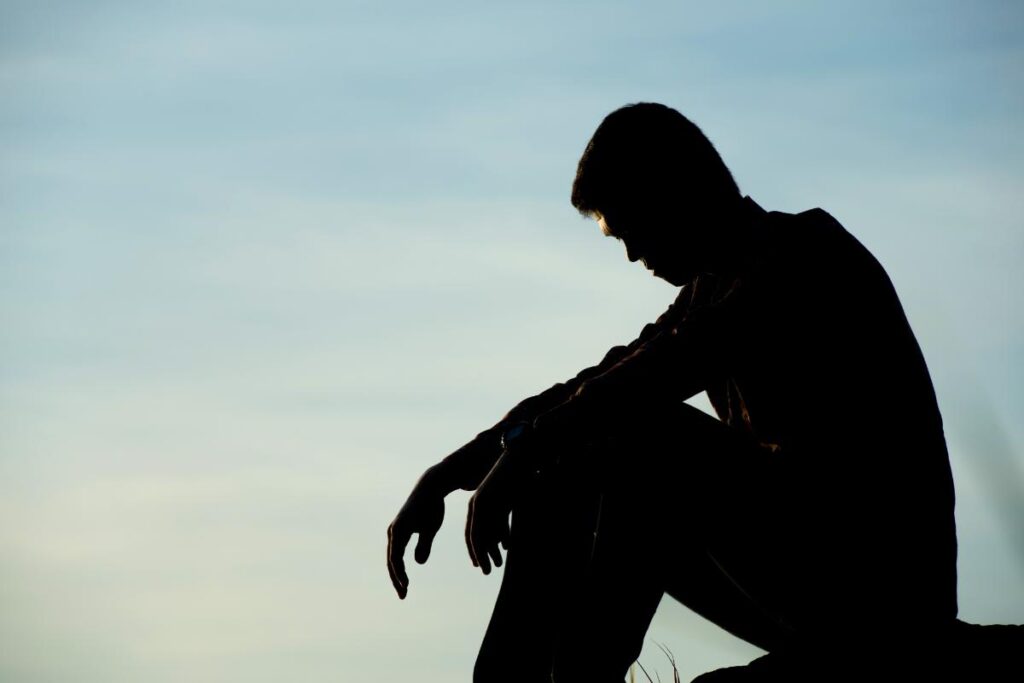a shadow of a person sits on a hill and wonders is heroin an opioid